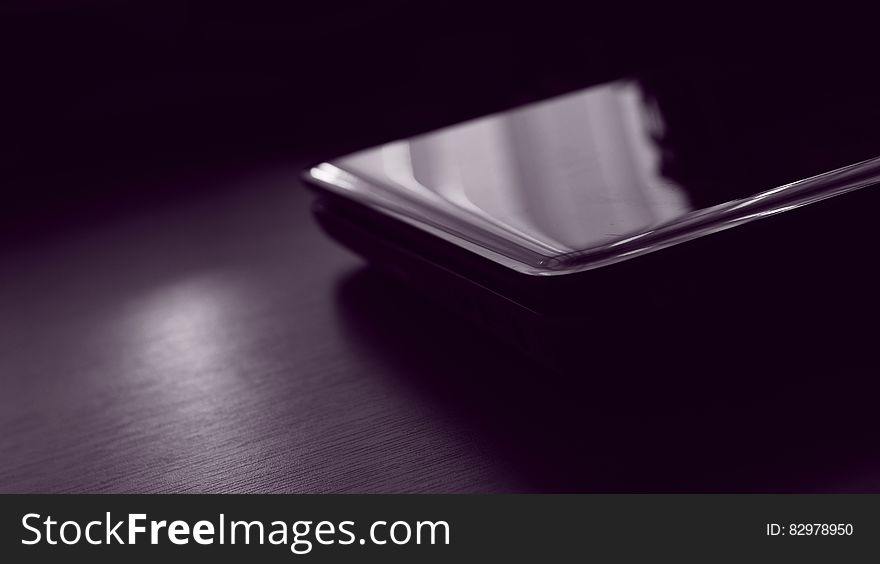 A close up of a smartphone on a table. A close up of a smartphone on a table.