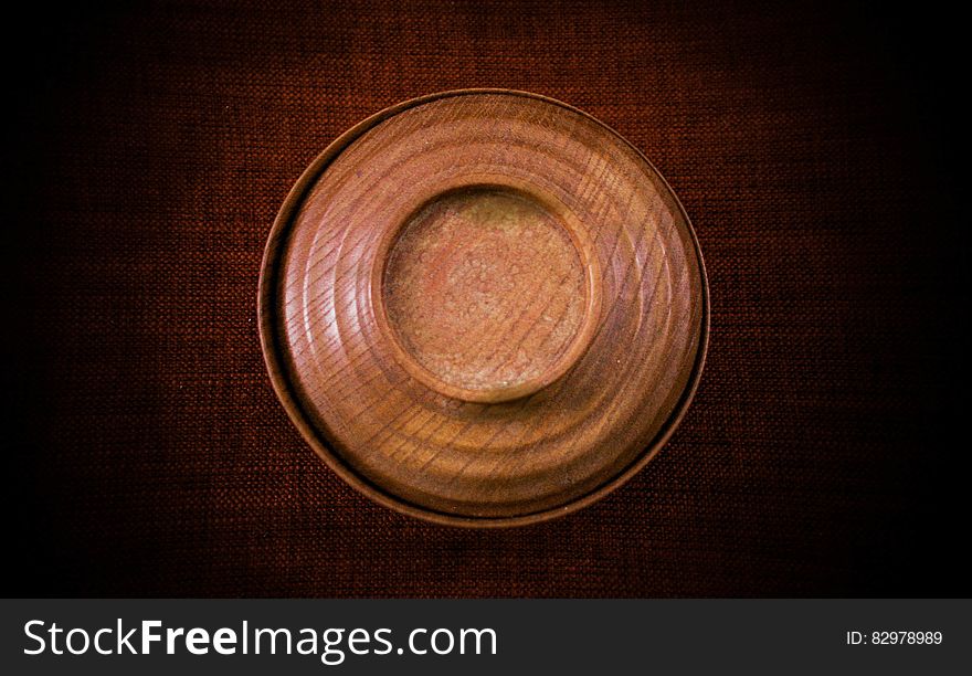 An old wooden bowl on wood background. An old wooden bowl on wood background.