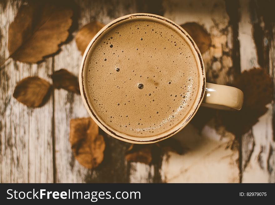 White Ceramic Mug over Brown Table