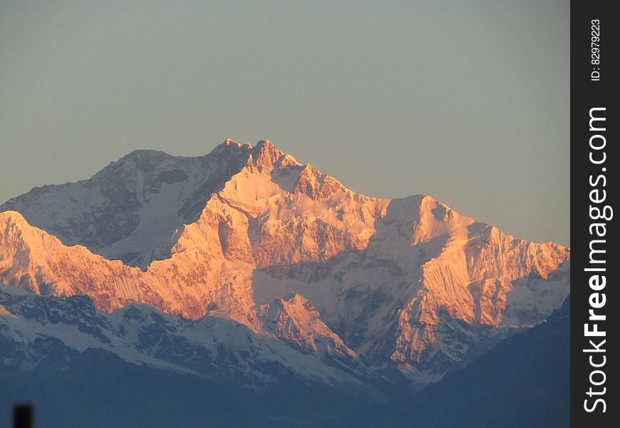 Scenic View Of Snowcapped Mountains Against Sky At Sunset