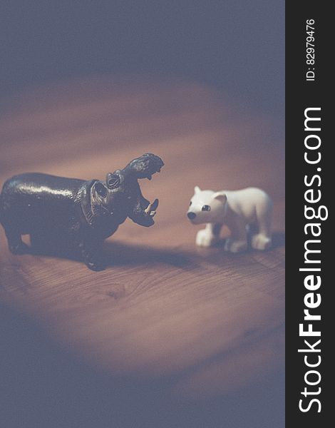 Close up of plastic toy miniature hippopotamus and polar bear on wooden table. Close up of plastic toy miniature hippopotamus and polar bear on wooden table.