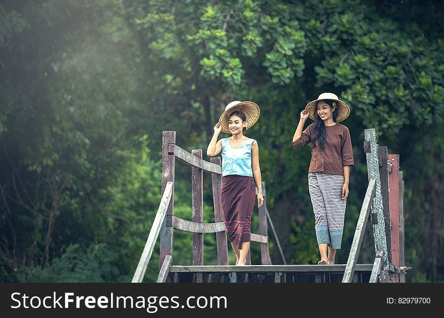 Full Length Of A Smiling Young Woman In Forest