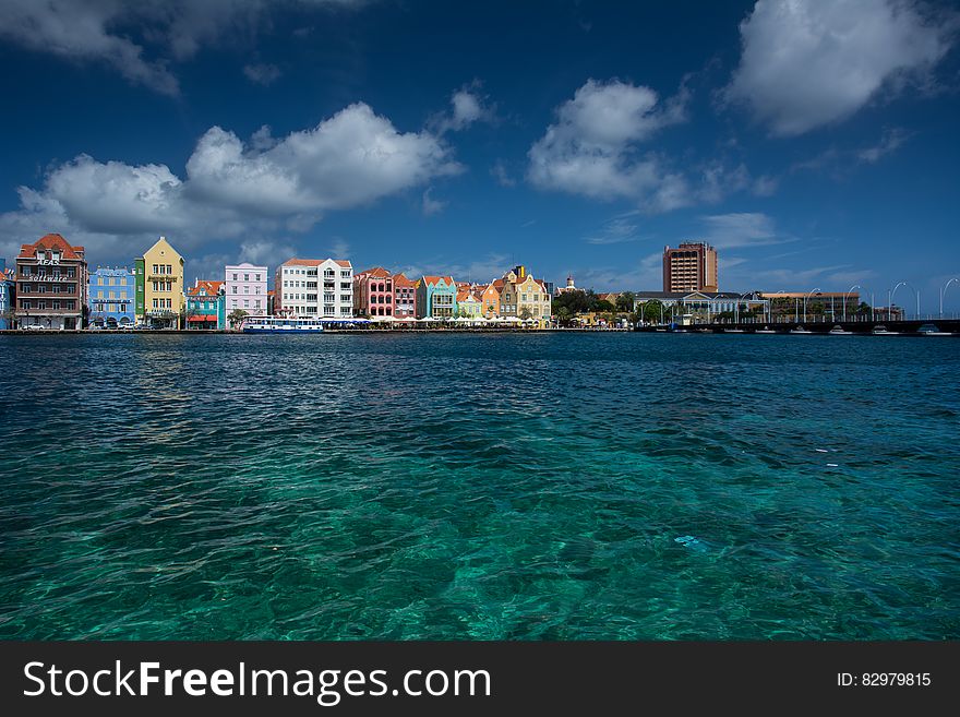 Colorful buildings along waterfront in Willemstad, Curacao in Dutch Antilles against blue skies. Colorful buildings along waterfront in Willemstad, Curacao in Dutch Antilles against blue skies.