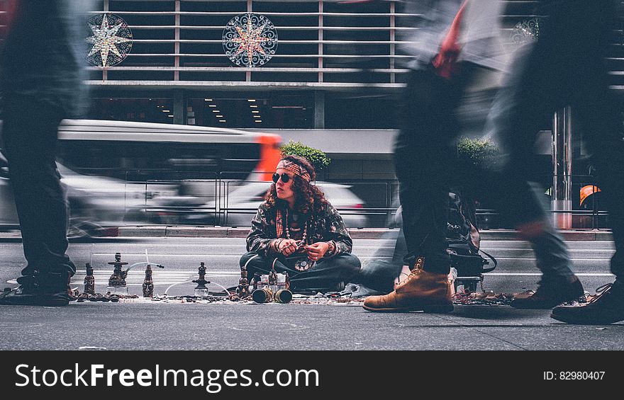 Man in hipster dress selling wares on city streets. Man in hipster dress selling wares on city streets.