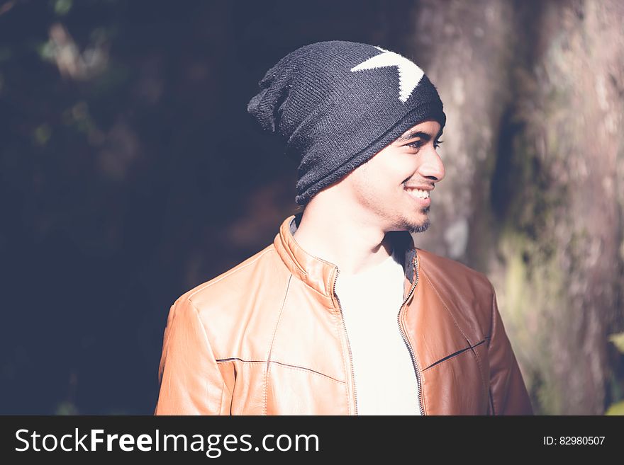 Outdoor portrait of man in jacket and hat smiling. Outdoor portrait of man in jacket and hat smiling.