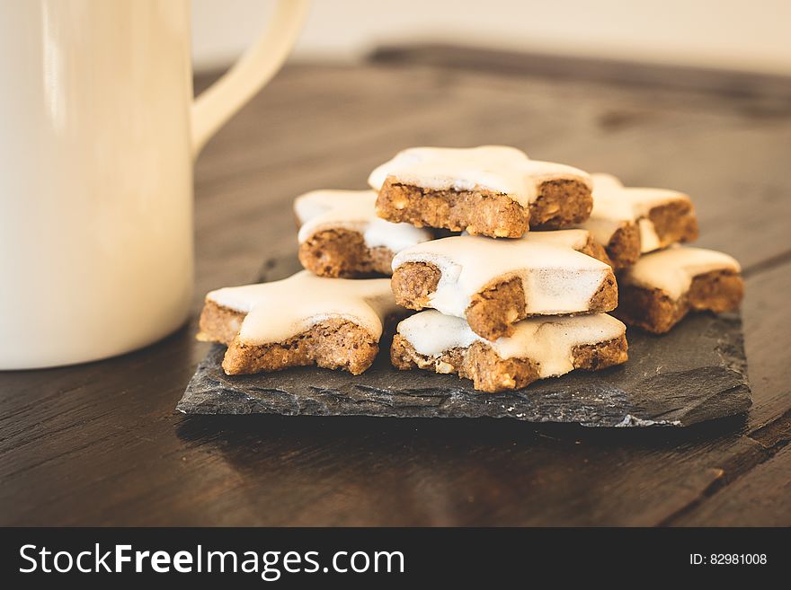 Stack of cookies with white icing on rustic table. Stack of cookies with white icing on rustic table.