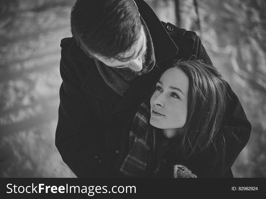 Man Hugging Smiling Woman from Behind