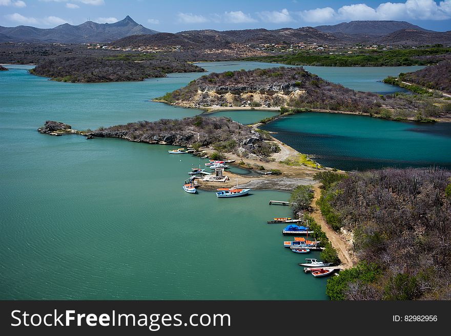 Aerial view of colorful boats in harbor along coastline of Curacao, Dutch Antilles on sunny day. Aerial view of colorful boats in harbor along coastline of Curacao, Dutch Antilles on sunny day.