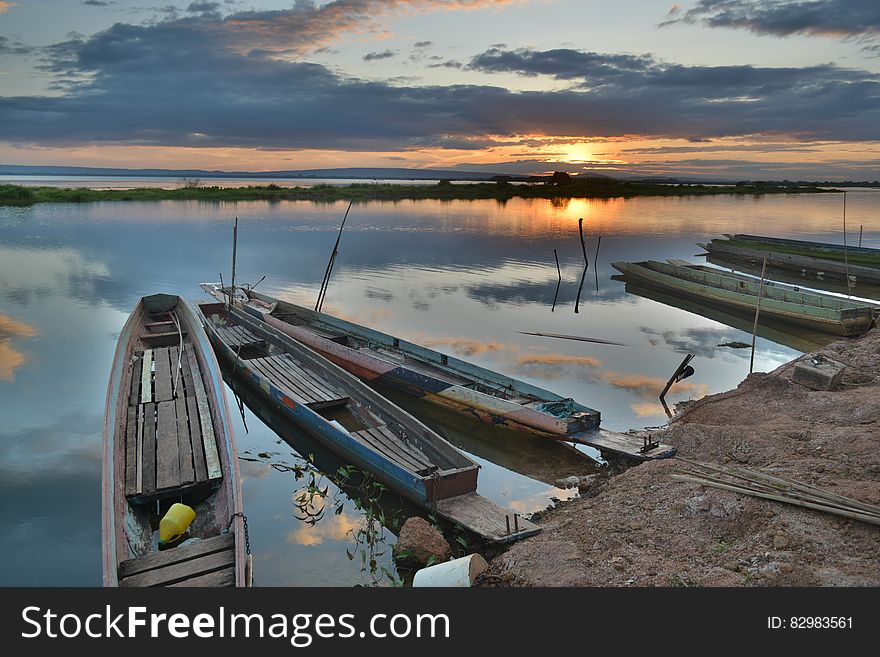 Canoe on Seashore during Sunset