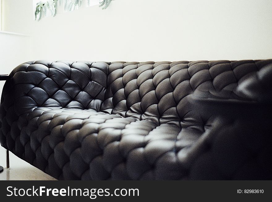 Luxurious leather couch in modern living room with high key white background and copy space.