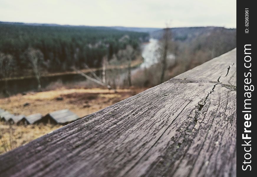 Close up of wooden board overlooking river valley in countryside. Close up of wooden board overlooking river valley in countryside.