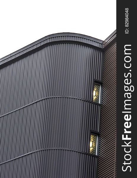 Exterior wall with windows of modern building against overcast skies. Exterior wall with windows of modern building against overcast skies.