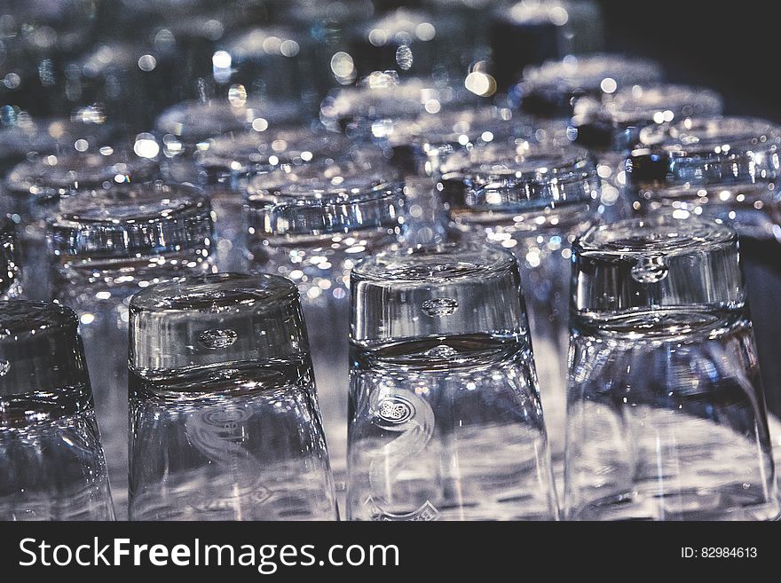 Close up of tray of clean glasses turned upside down.