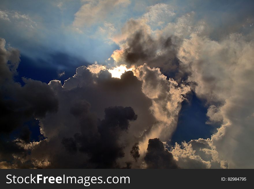 Gray Clouds Cover Sun Under Blue Sky