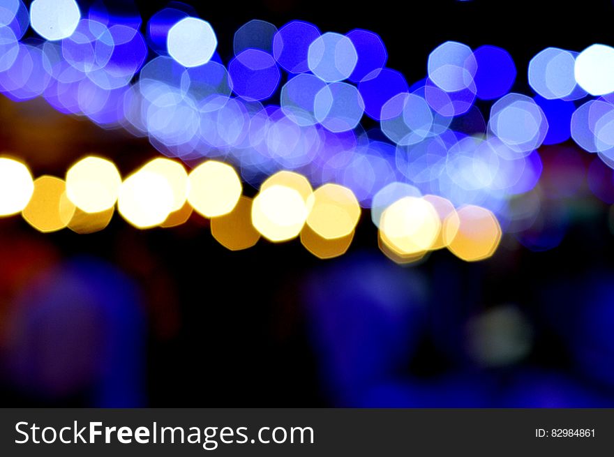 Bright bokeh lights in blue and yellow at night. Bright bokeh lights in blue and yellow at night.