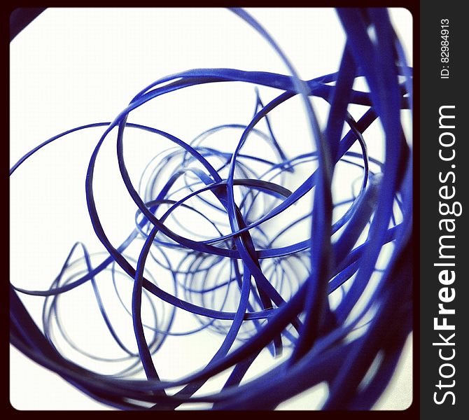 Abstraction of looping coils of blue cables on white. Abstraction of looping coils of blue cables on white.
