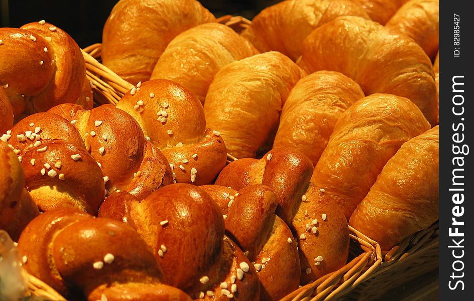 Close up of baked pretzel rolls and croissants in wicker baskets. Close up of baked pretzel rolls and croissants in wicker baskets.