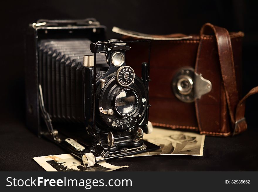 Black Classic Camera Near Brown Leather Bag