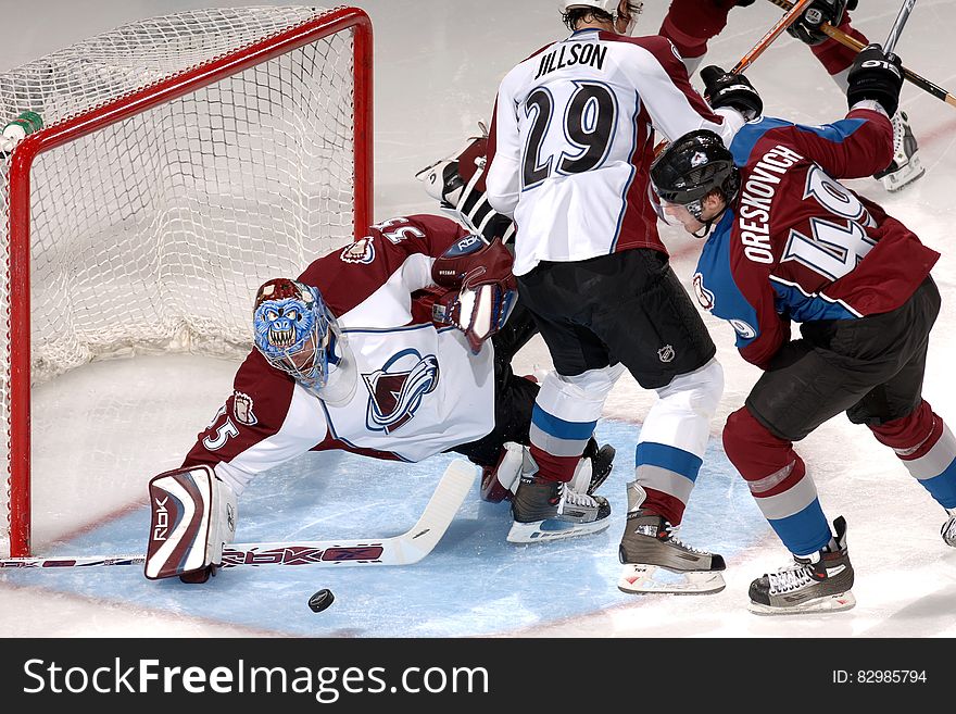 Colorado Avalanche hockey goaltender saving goal during game against Vancouver Canucks. Colorado Avalanche hockey goaltender saving goal during game against Vancouver Canucks.