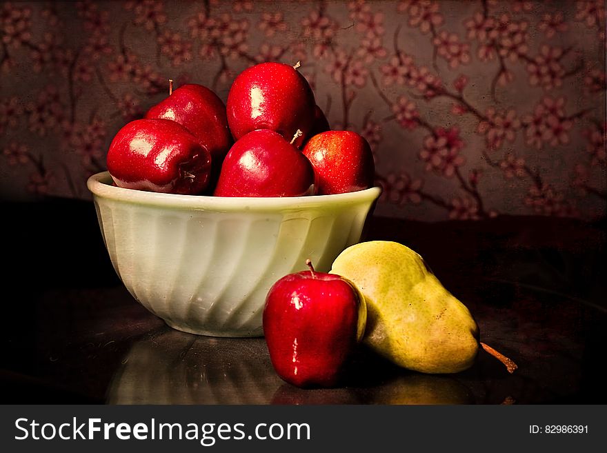 Bowl of red apples on table still life.