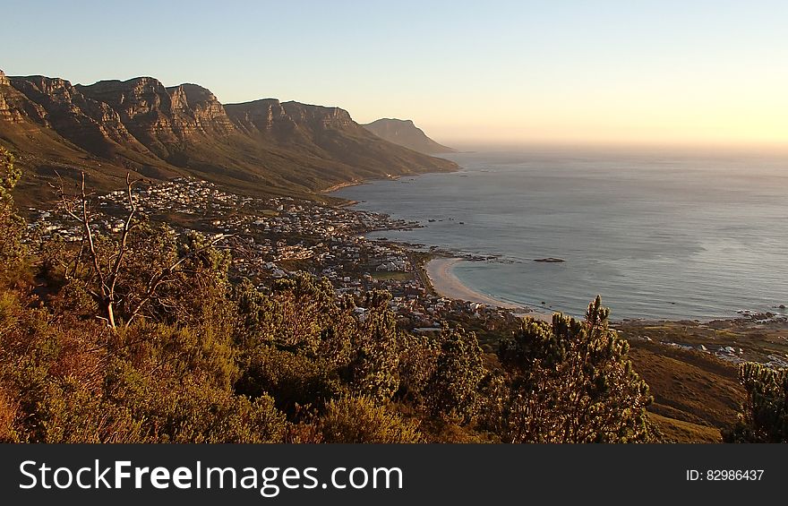 Rocky shores of South African beach at sunset.