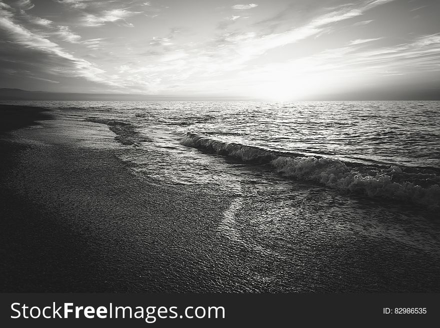 Waves on beach in black and white