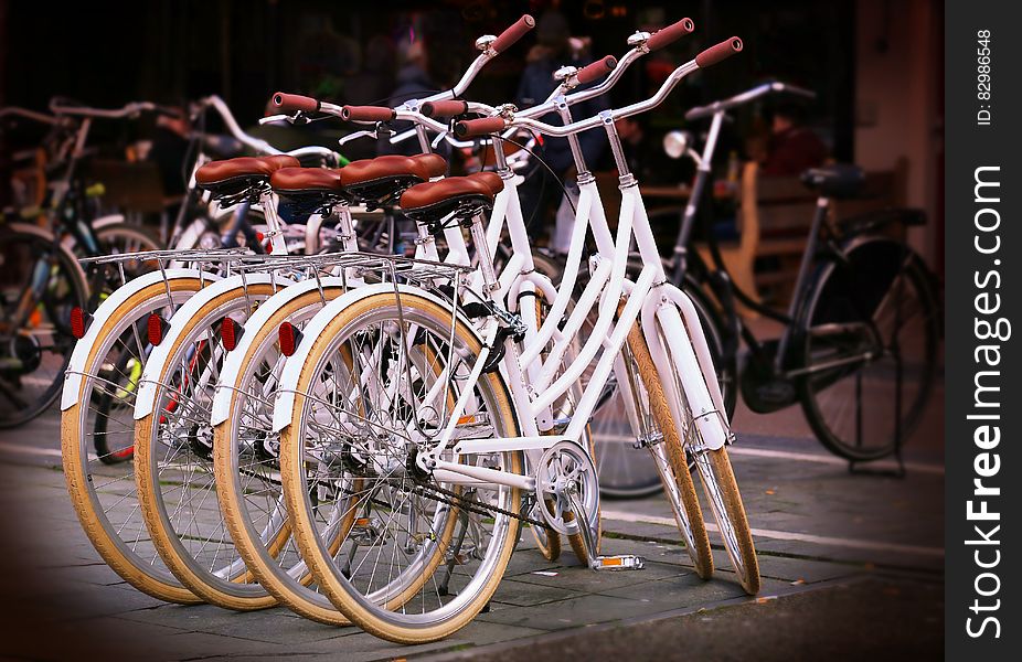 White ladies bicycles in an urban environment offered free for use to minimize pollution.