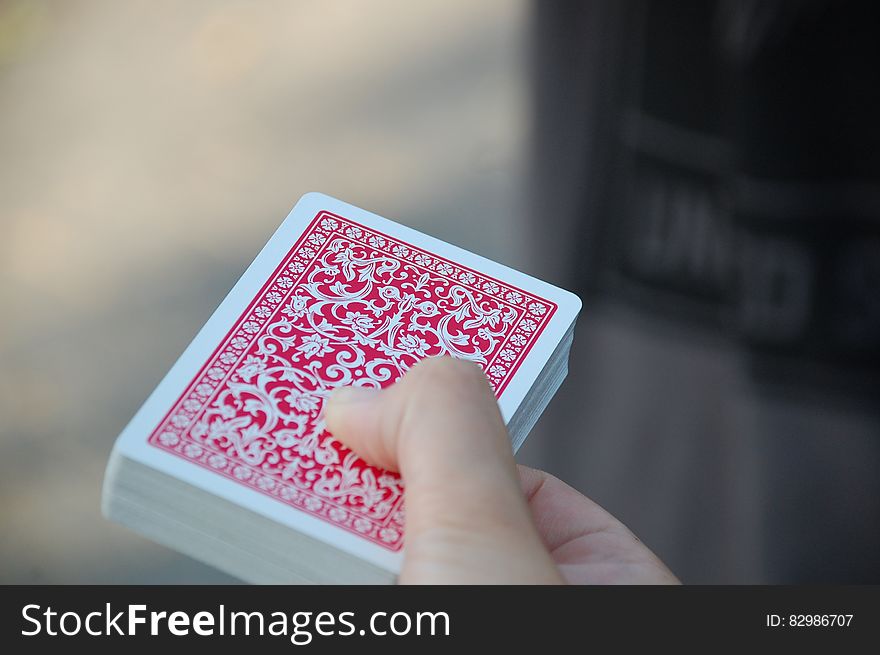 Close up of deck of red playing cards in hand. Close up of deck of red playing cards in hand.