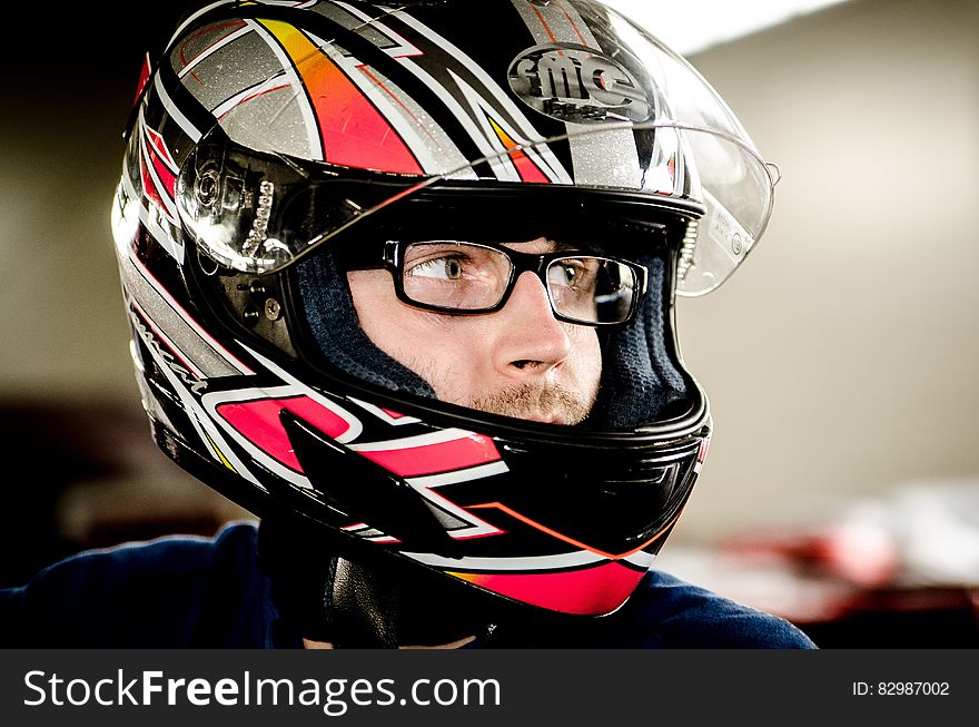 Portrait of man in glasses wearing motorcycle crash helmet. Portrait of man in glasses wearing motorcycle crash helmet.
