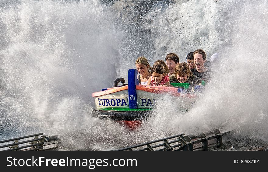 Children smiling, laughing and screaming with joy on a water park roller coaster ride. Children smiling, laughing and screaming with joy on a water park roller coaster ride.
