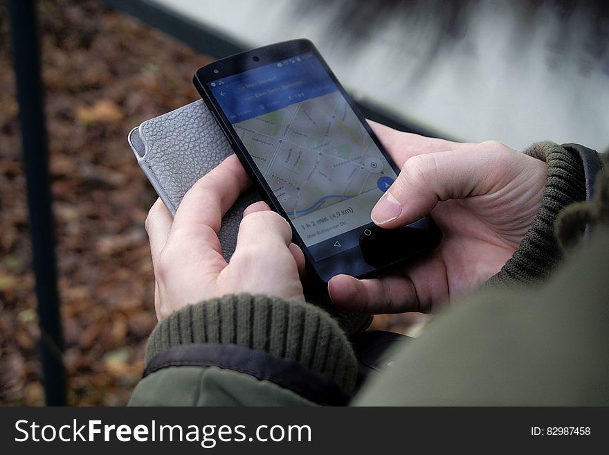 Person Looking At Map On Smartphone