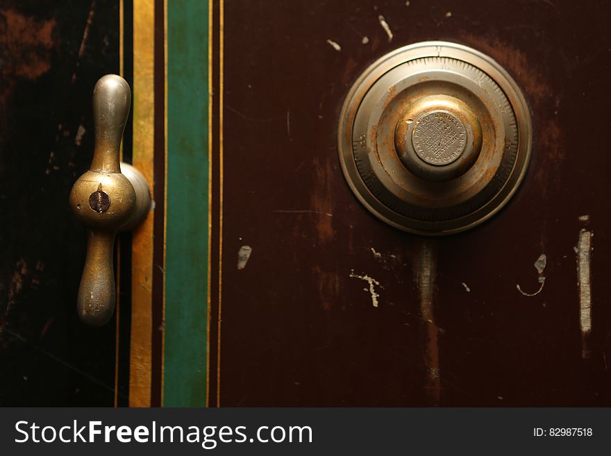 The door of a safe with a brass handle and a combination lock. The door of a safe with a brass handle and a combination lock.