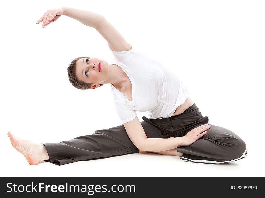 Brunette Short Haired Woman Stretching Arm Overhead in Yoga Pose