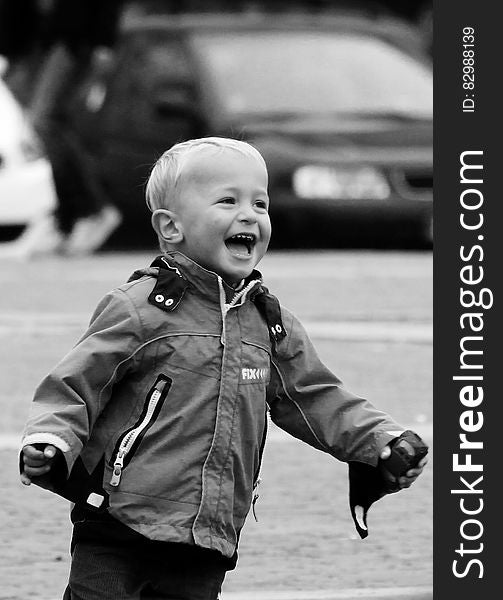 Boy Wearing Jacket on Street in Grayscale Photography