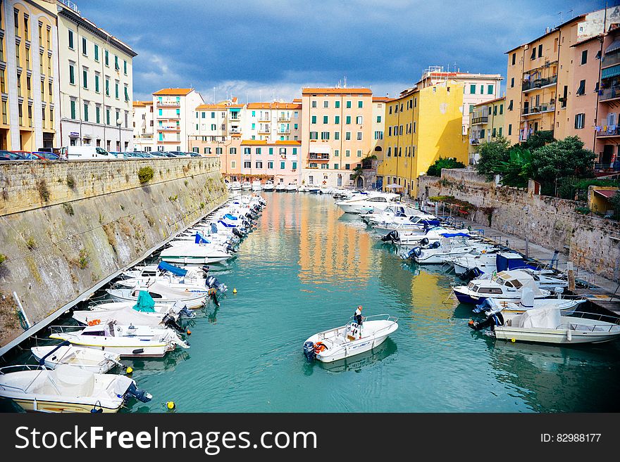 Boats anchored in a harbor on a canal in Italy. Boats anchored in a harbor on a canal in Italy.