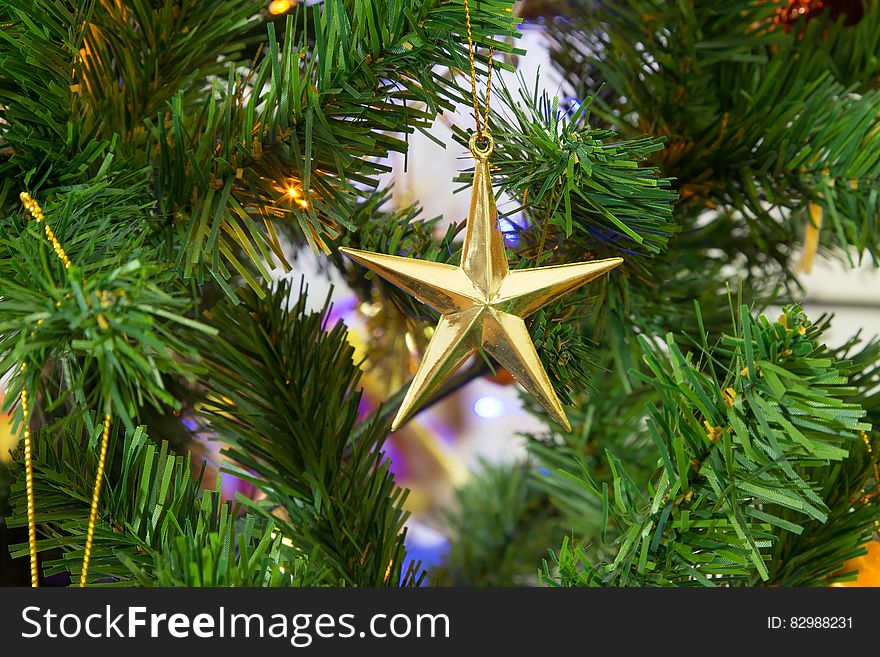 A star-shaped bauble on a Christmas tree. A star-shaped bauble on a Christmas tree.
