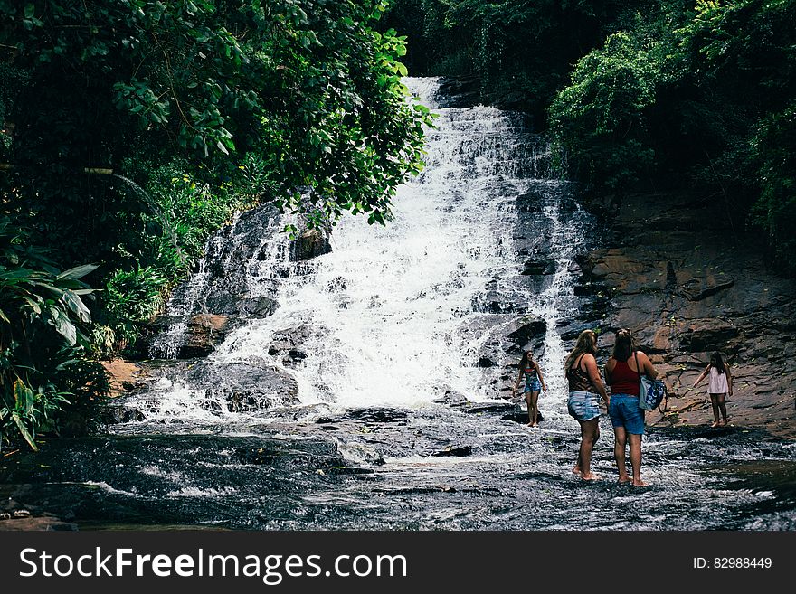 Travelers At Waterfall