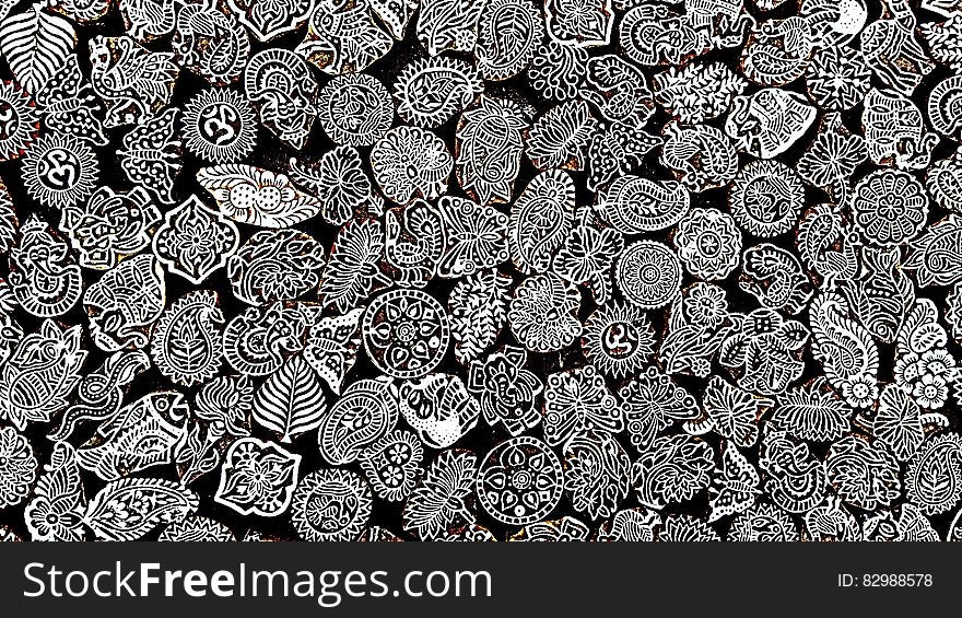 Background of tiny historic patterned artistic objects created in white on black. Background of tiny historic patterned artistic objects created in white on black.