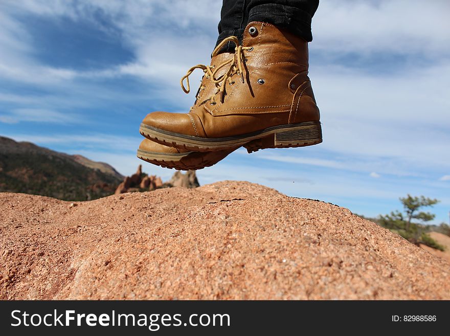 Person Wearing Brown Leather Work Boots During Daytime