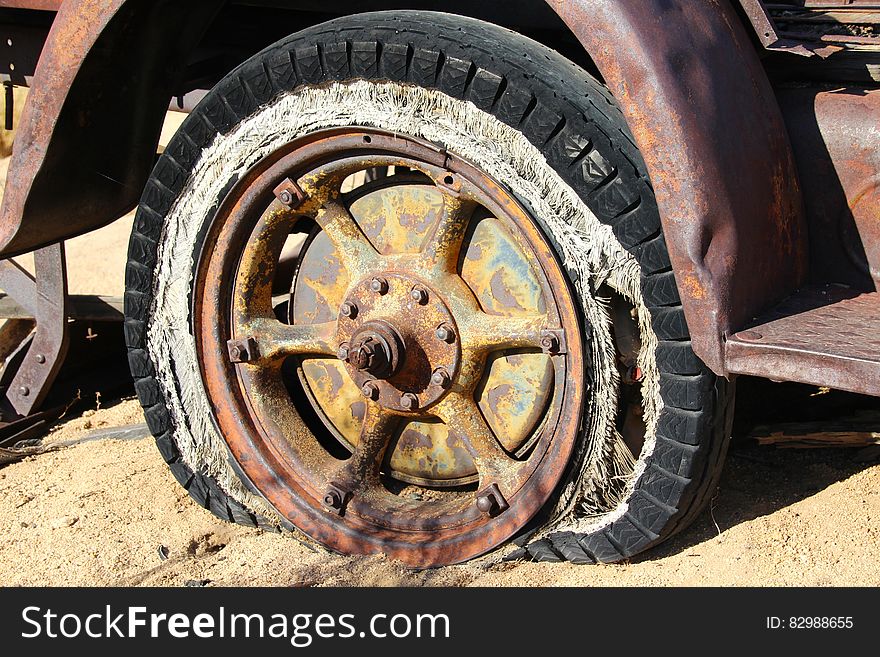 Brown Spoke Car Wheel In Brown Sand During Daytime