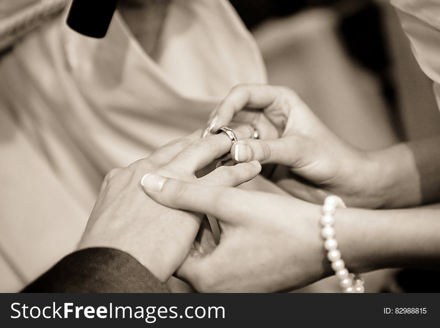 Person Putting Ring on Another Person in Grayscale Photography