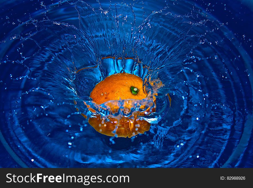 Orange Drop In Water In Time Laps Photography