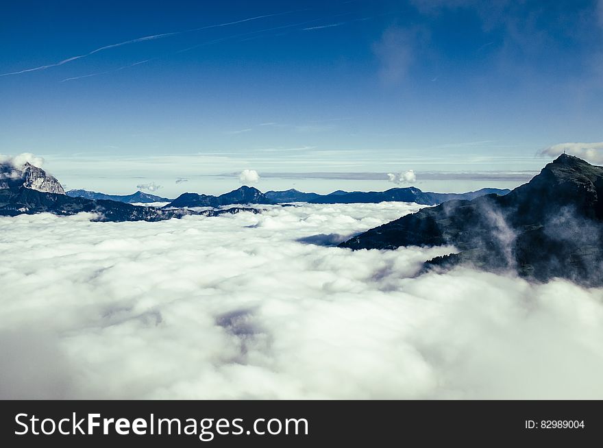 Black Mountain Over White Clouds