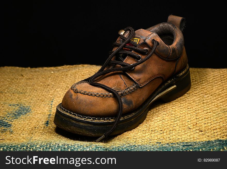 Brown And Black Leather Work Boots On Brown Surface