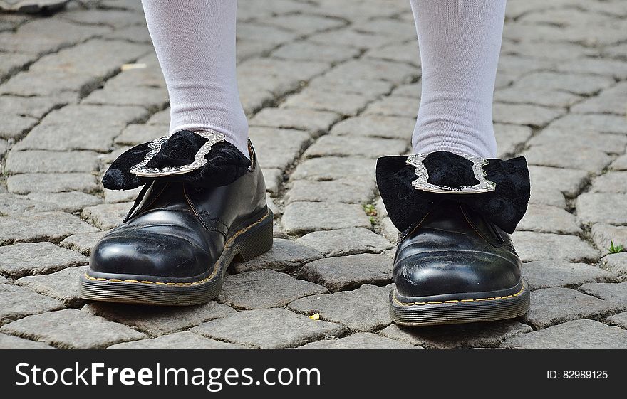 Person in Black Leather Shoes