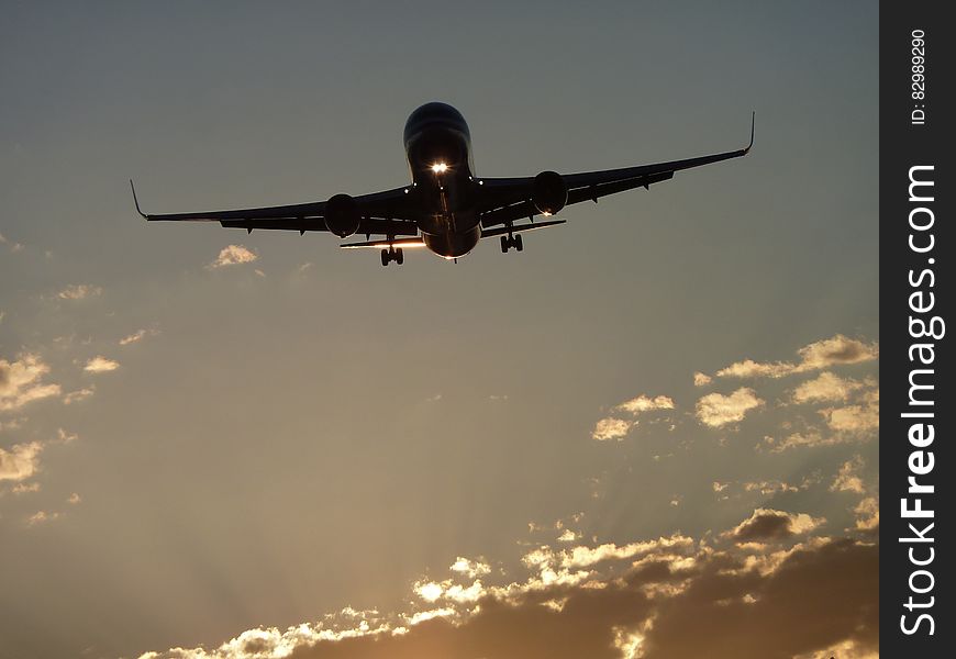 Airplane On Sky During Sunset