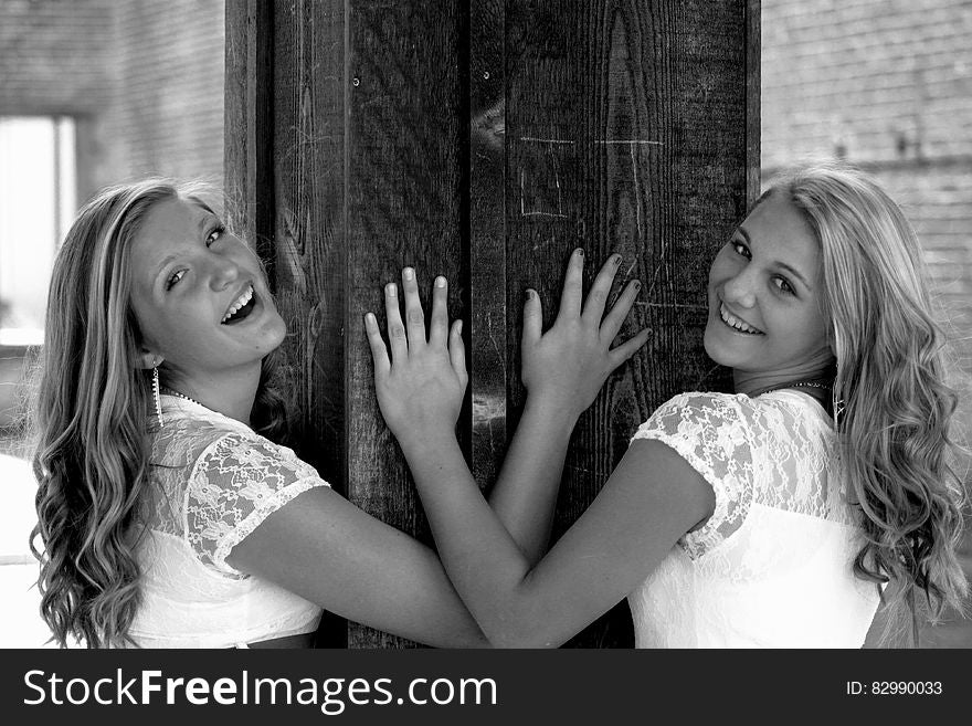 Two Women Wearing White and Lace Tops Smiling