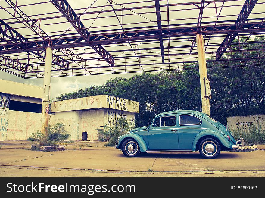 Blue Volkswagen Beetle in Front of Building