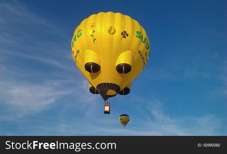 Yellow And Black Hot Air Balloons On Mid Air Under White Clouds Blue Sky During Daytime