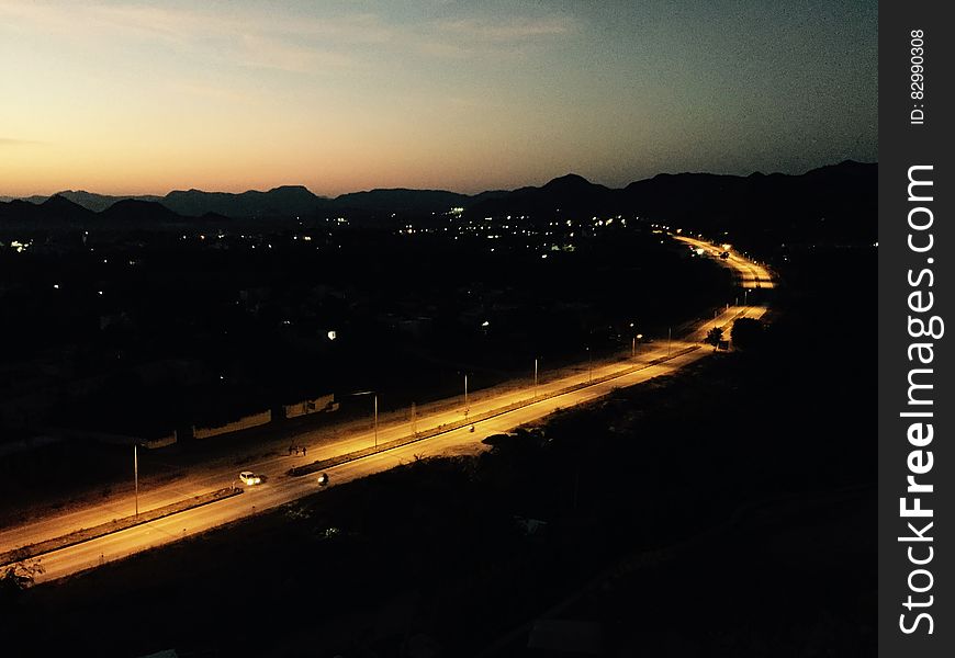 Empty highway illuminated at sunset through countryside. Empty highway illuminated at sunset through countryside.